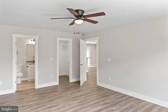 a bathroom with a granite countertop sink a toilet and shower
