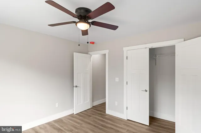 a view of a house with a backyard and a tree
