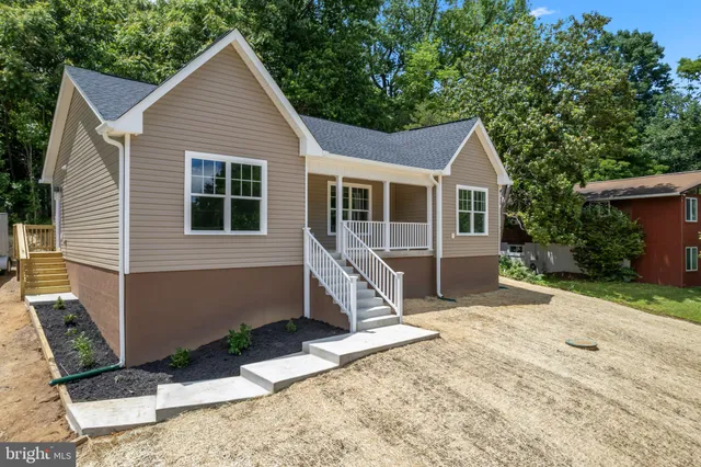 a view of a kitchen with a sink and dishwasher a refrigerator with wooden floor