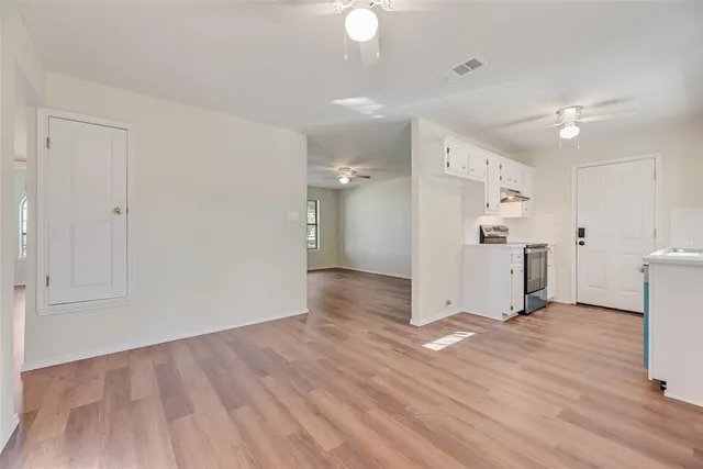 a view of a kitchen with a sink and a refrigerator