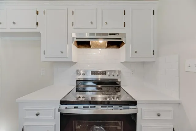a stove top oven sitting inside of a kitchen