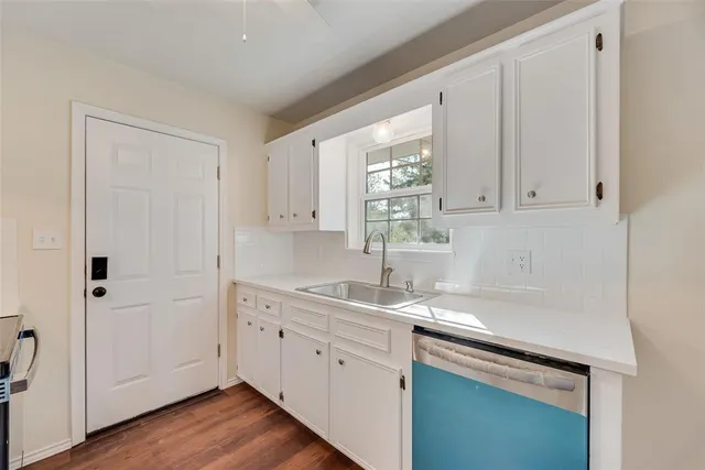 a kitchen with a sink cabinets and window