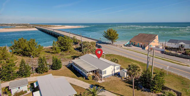 an aerial view of a house with a ocean view