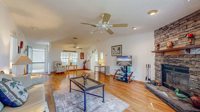 a living room with furniture a fireplace and a chandelier