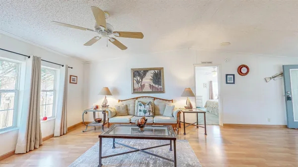 a living room with furniture and wooden floor