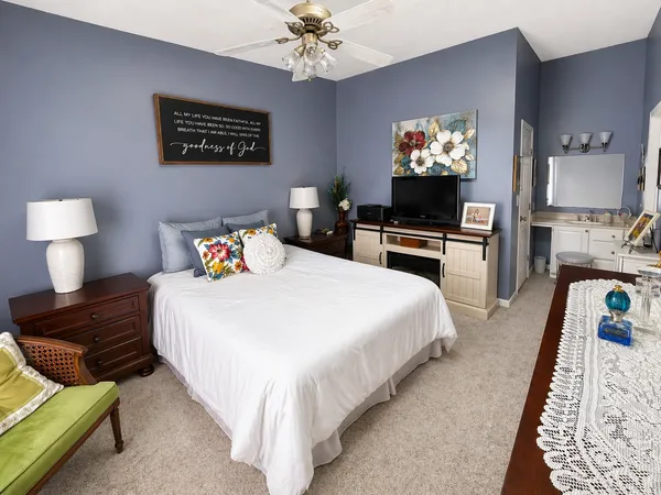 a bedroom with bed and a flat screen tv