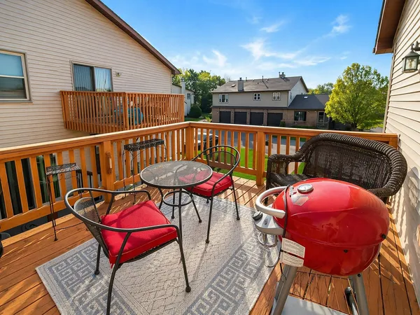 a balcony with table and chairs