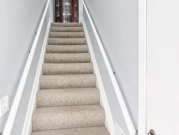 a view of staircase with white walls