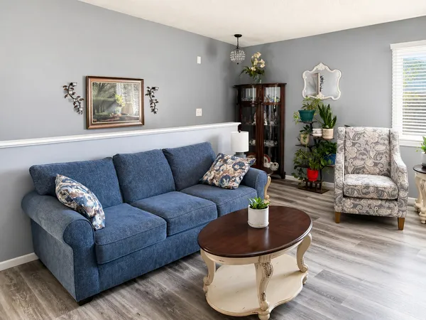 a living room with furniture and a chandelier