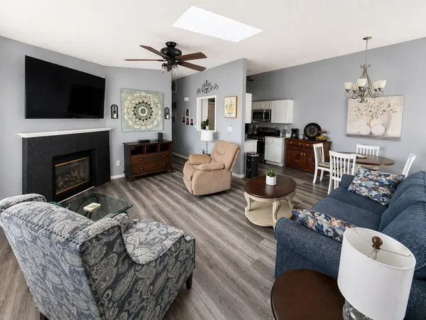 a living room with furniture a flat screen tv and a fireplace