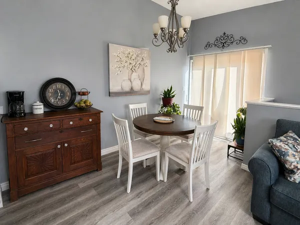a view of a dining room with furniture and chandelier