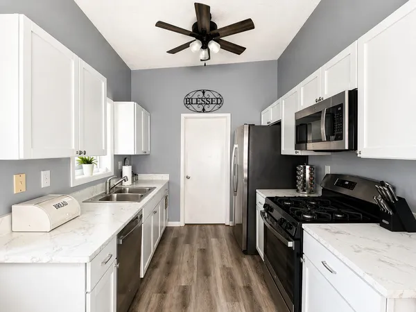 a kitchen with a sink stove and refrigerator