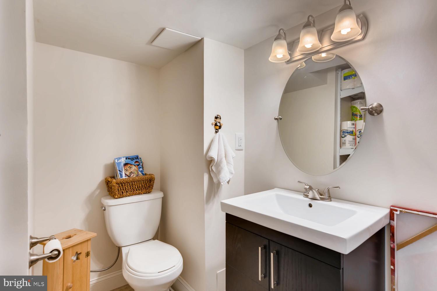 8360 Hillendale Road Baltimore, MD 21234 - Photo 22 of 30 a bathroom with a toilet a sink and mirror