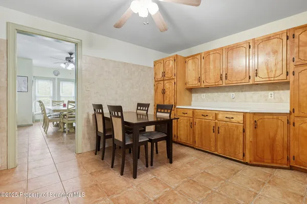 a kitchen with cabinets and chairs