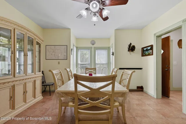 a dining room with furniture and window
