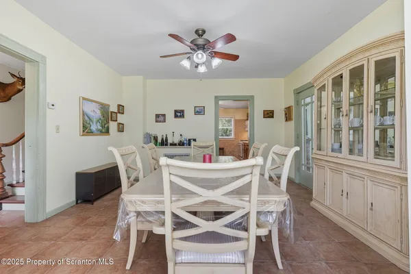 a view of a dining room with furniture and a chandelier
