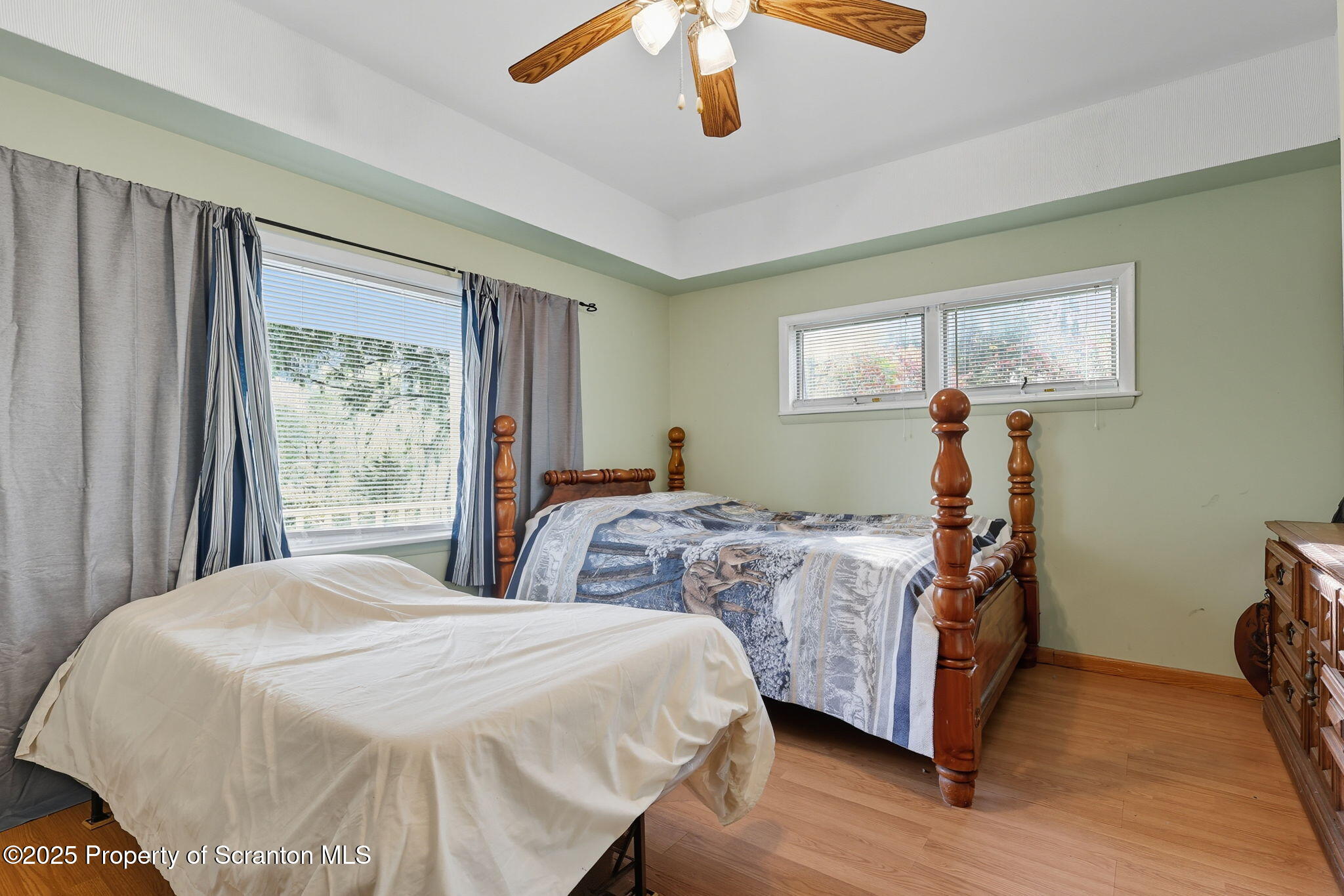 505 Creek Road Kingsley, PA 18826 - Photo 18 of 61 a bedroom with a large bed and a window
