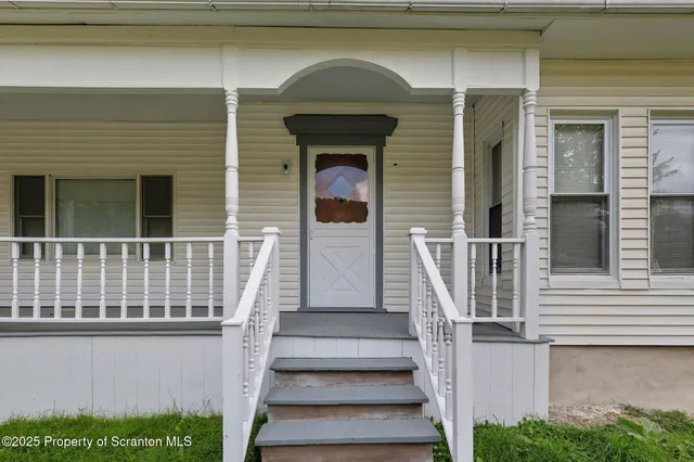a view of front door of house with stairs