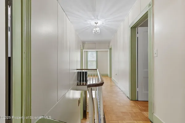 a bedroom with a bed and a lamp on dresser