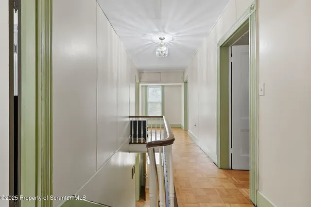 a bedroom with a bed and a lamp on dresser