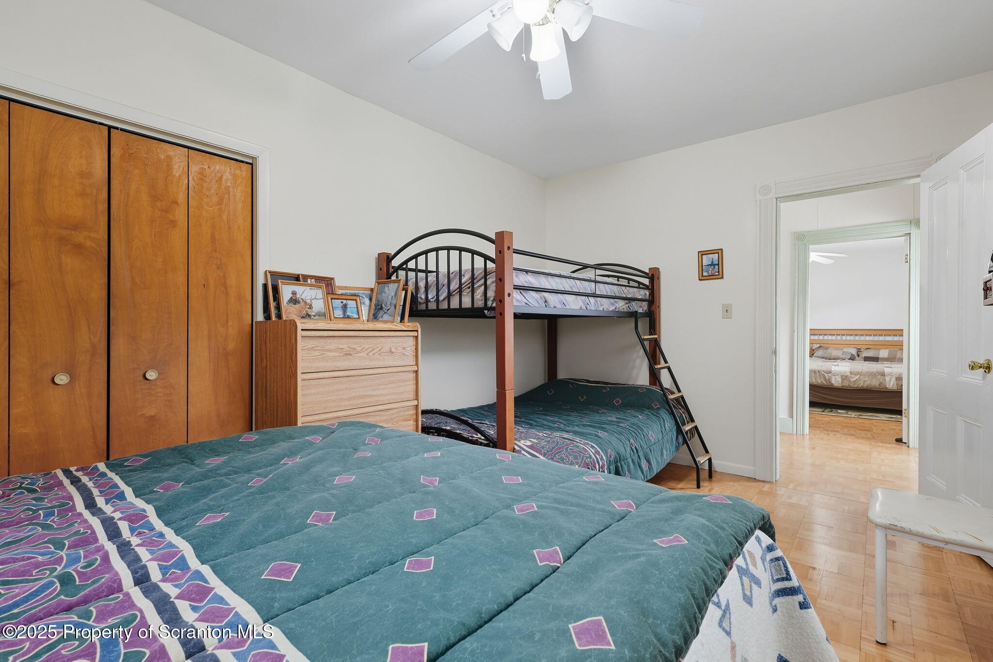 505 Creek Road Kingsley, PA 18826 - Photo 28 of 61 a bedroom with a bed and a chandelier