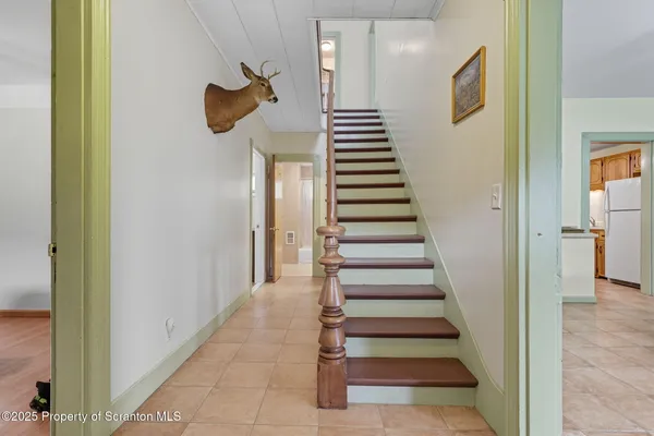 a view of a hallway with front door wooden floor and stairs