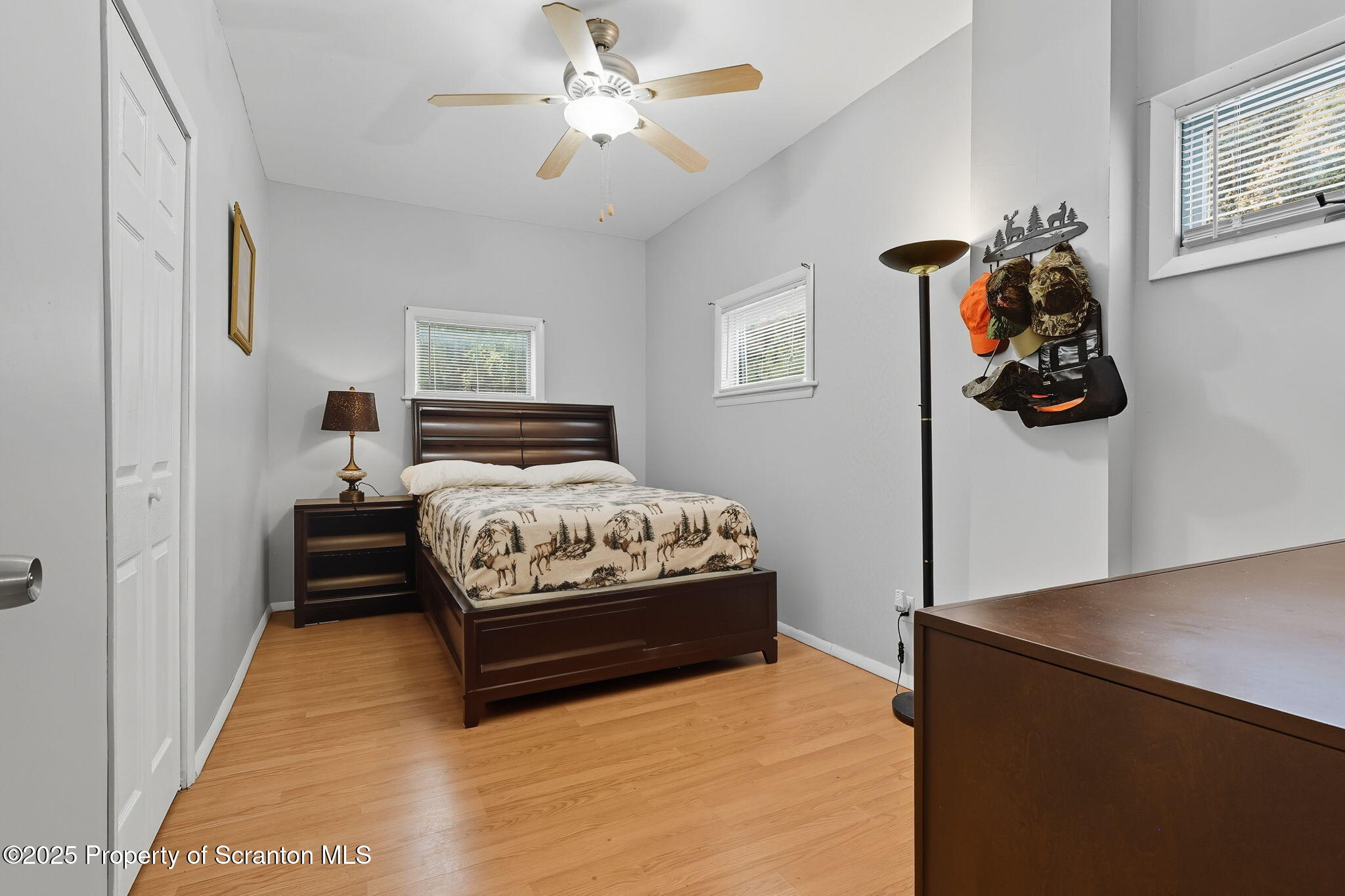 505 Creek Road Kingsley, PA 18826 - Photo 32 of 61 a bedroom with a bed and a chandelier