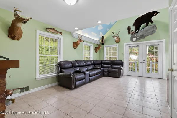 a living room with furniture chess board and a window