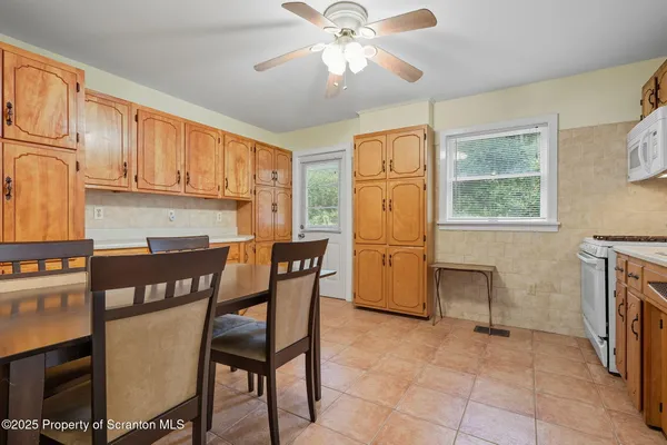 a kitchen with a dining table and chairs