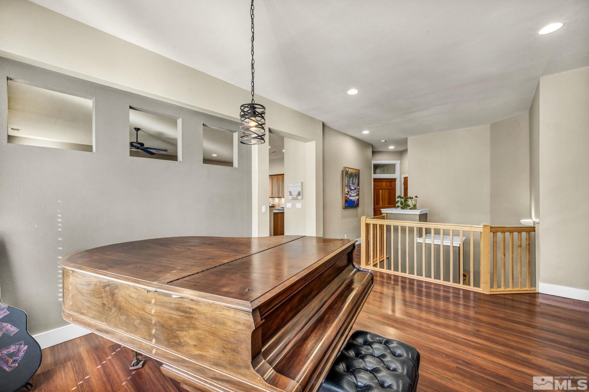4975 Turning Leaf Way Reno, NV 89519 - Photo 5 of 40 a living room with hard wood flooring and a chandelier