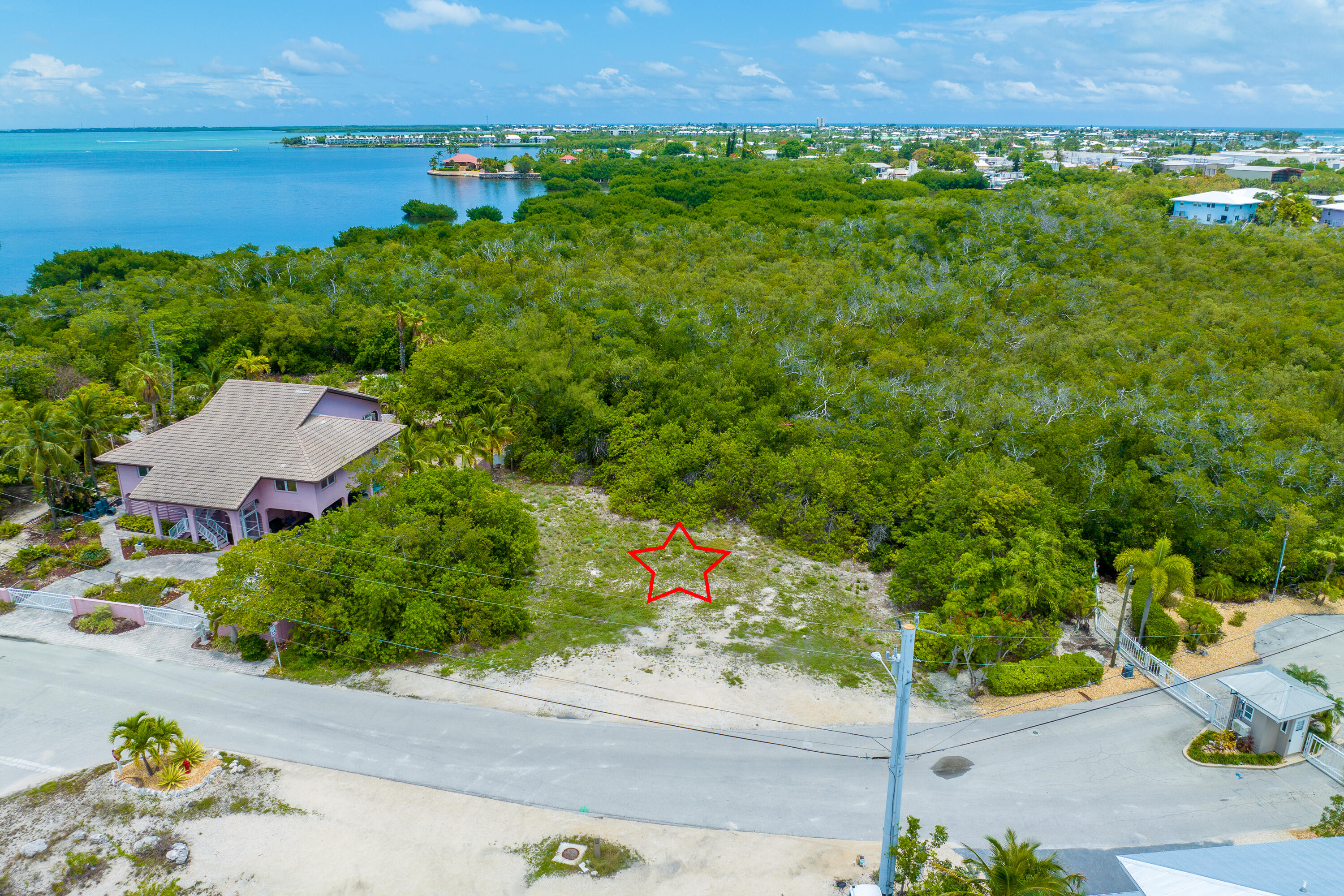 199 Stirrup Key Boulevard Marathon, FL 33050 - Photo 4 of 24 an aerial view of a house with a garden and lake view