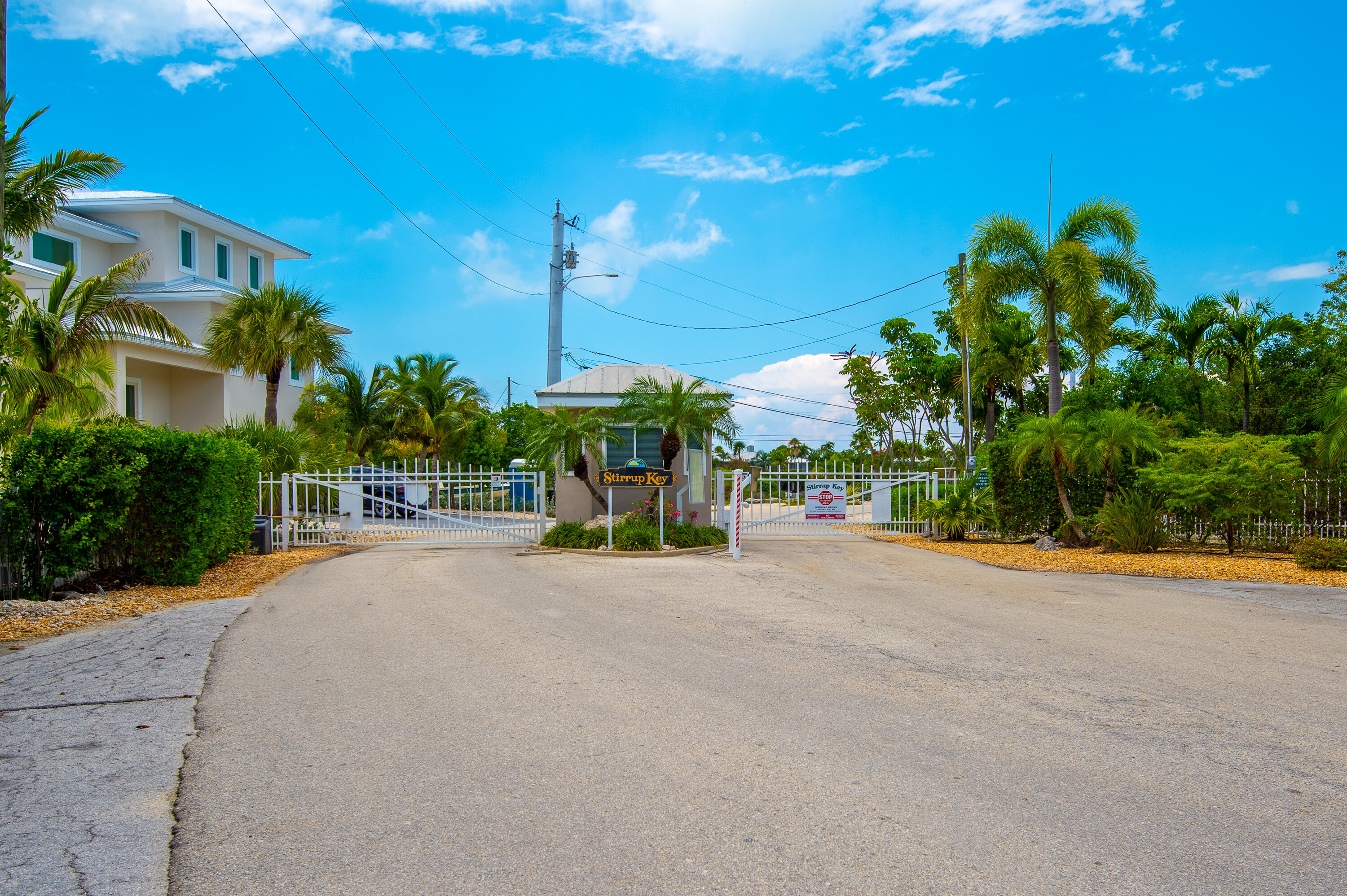 199 Stirrup Key Boulevard Marathon, FL 33050 - Photo 8 of 24 a view of a street with a building and palm trees
