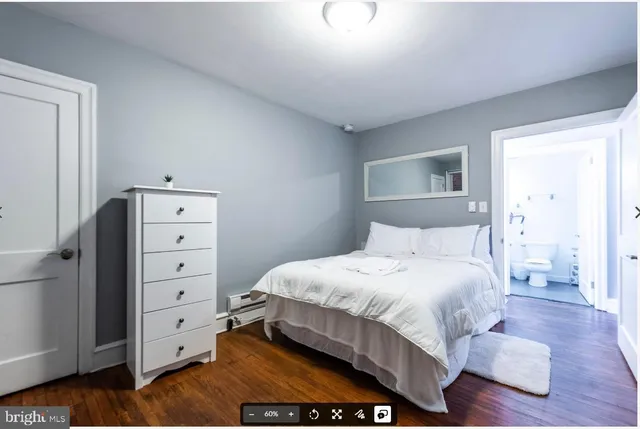 a bedroom with a bed and a television