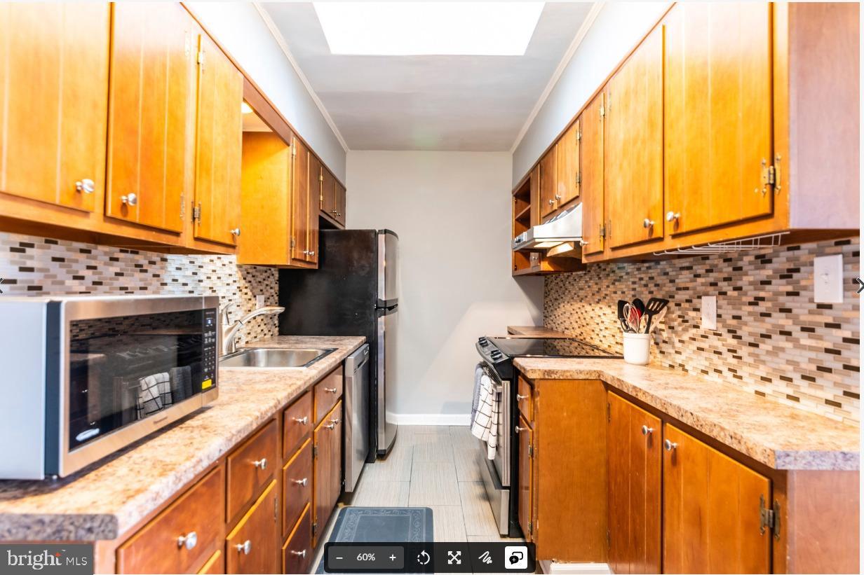 8526 Germantown Avenue, Unit 2 Philadelphia, PA 19118 - Photo 7 of 19 a kitchen with stainless steel appliances a stove a sink and a microwave