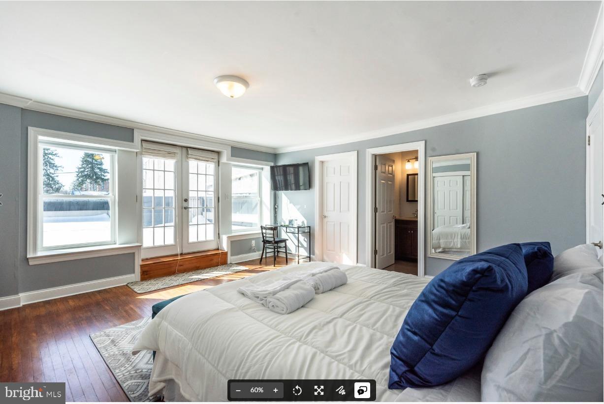 8526 Germantown Avenue, Unit 2 Philadelphia, PA 19118 - Photo 9 of 19 a bedroom with a bed and a large window