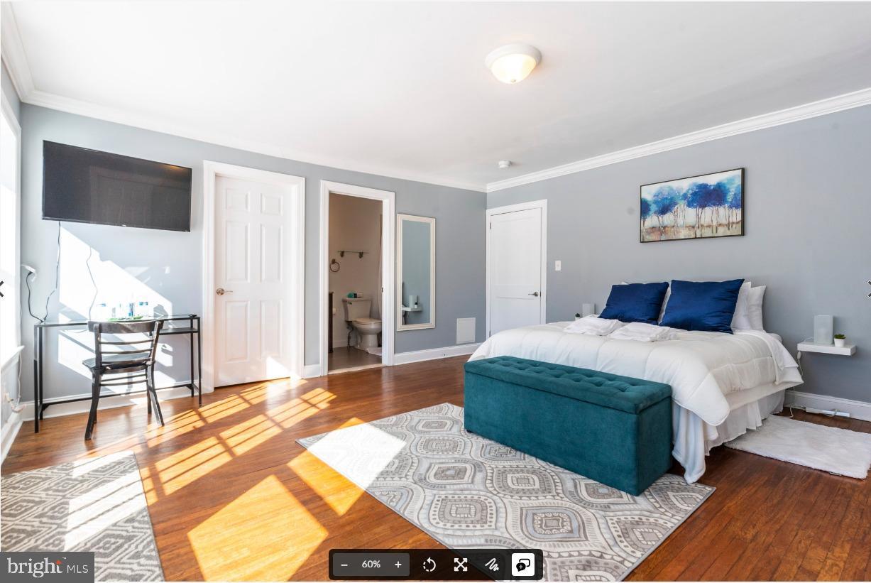 8526 Germantown Avenue, Unit 2 Philadelphia, PA 19118 - Photo 10 of 19 a bedroom with a large bed and a chandelier