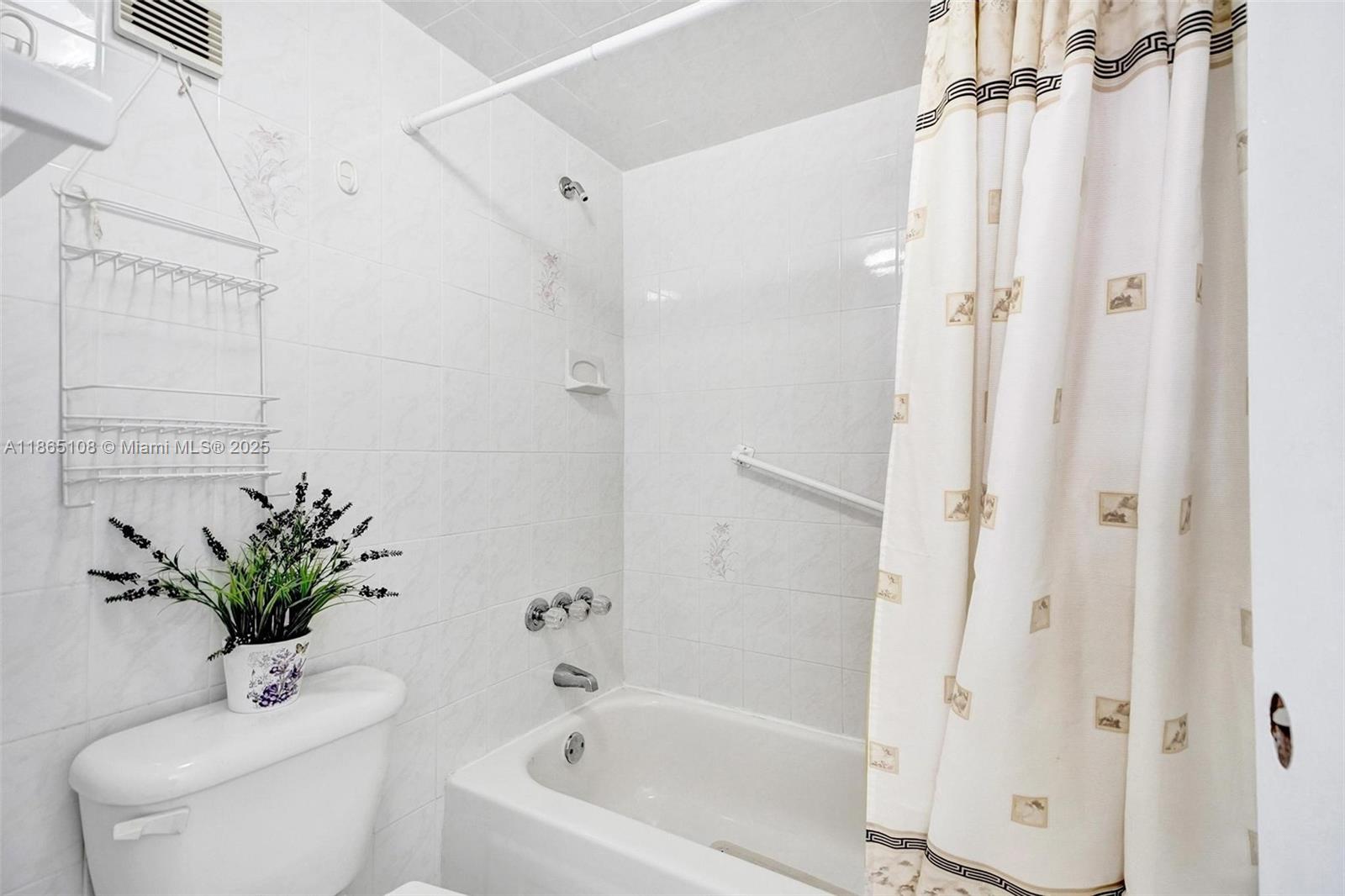 1900 West 68th Street, Unit C203 Hialeah, FL 33014 - Photo 13 of 29 a white bath tub sitting next to a white toilet