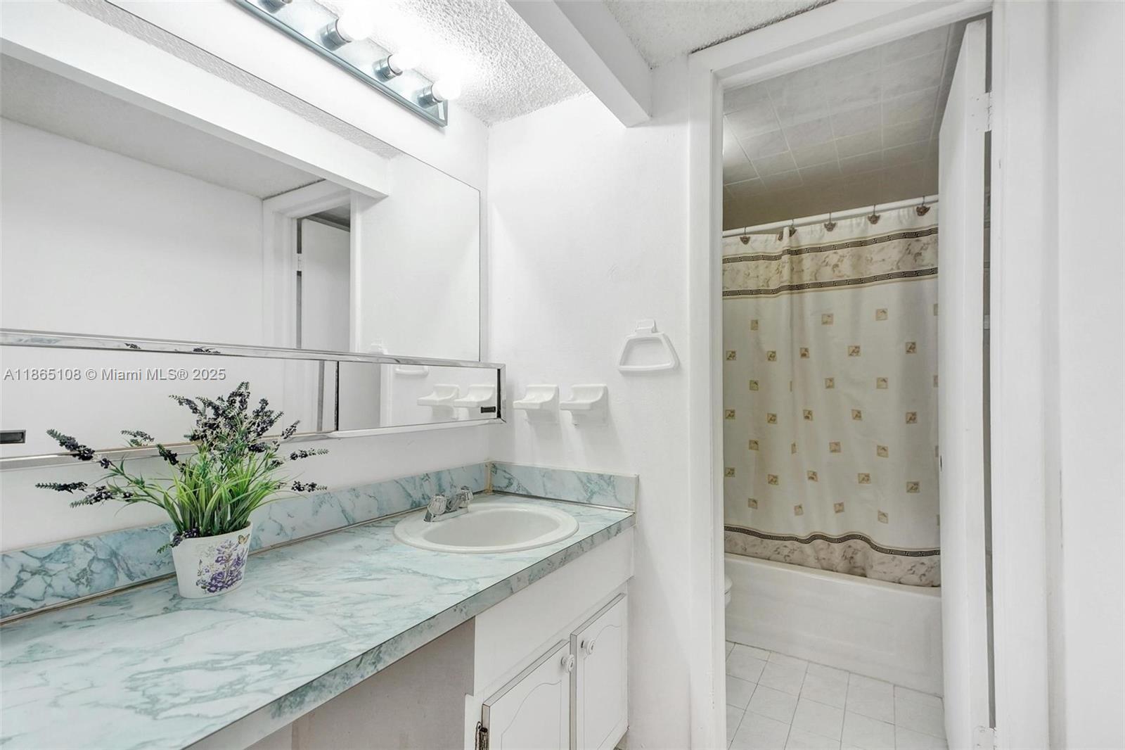 1900 West 68th Street, Unit C203 Hialeah, FL 33014 - Photo 14 of 29 a bathroom with a granite countertop sink a mirror and shower