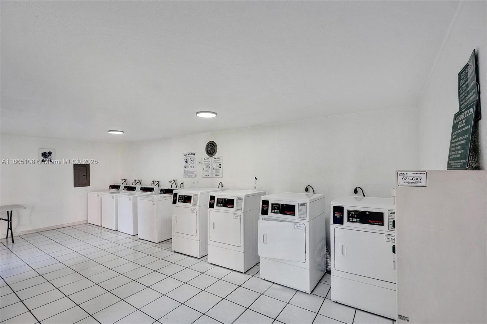 1900 West 68th Street, Unit C203 Hialeah, FL 33014 - Photo 20 of 29 a kitchen with white cabinets and white appliances
