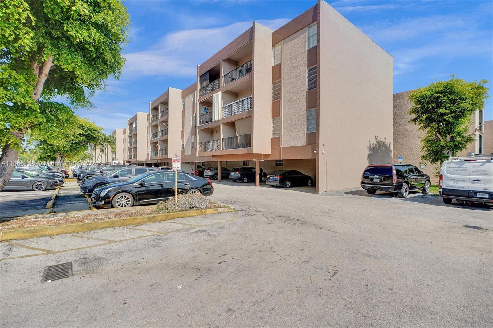 1900 West 68th Street, Unit C203 Hialeah, FL 33014 - Photo 24 of 29 a car parked in front of a building