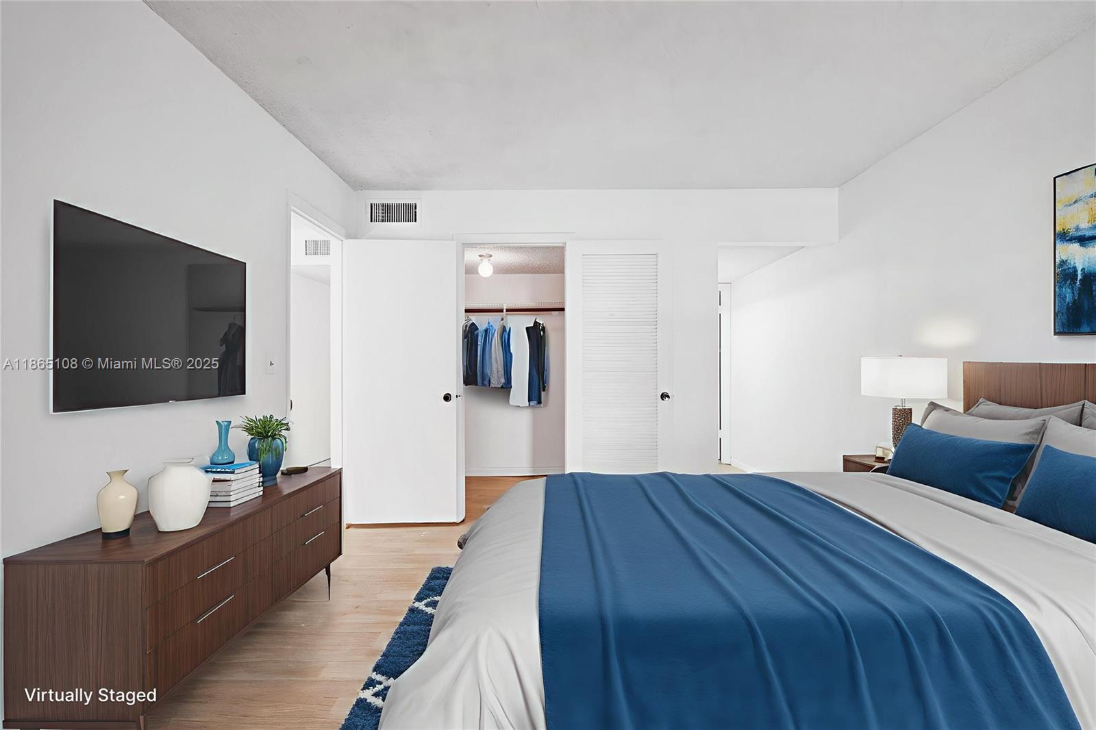 1900 West 68th Street, Unit C203 Hialeah, FL 33014 - Photo 10 of 29 a bedroom with a bed and a flat screen tv