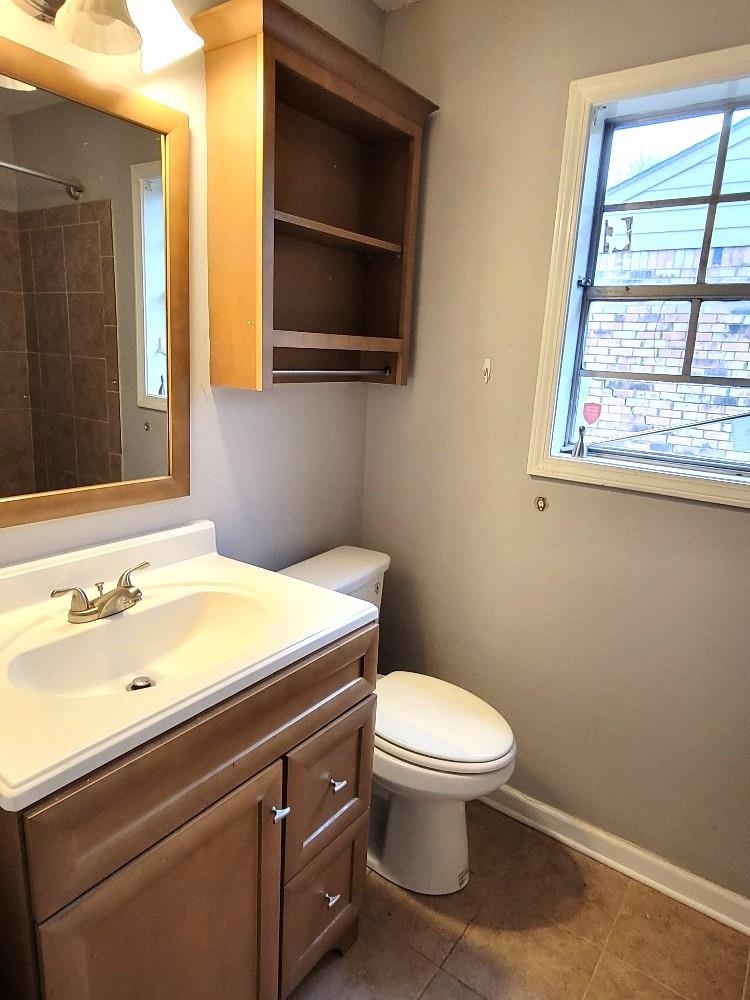 4063 Double Tree Road Memphis, TN 38109 - Photo 12 of 14 Bathroom with tile patterned flooring, vanity, toilet, and a shower