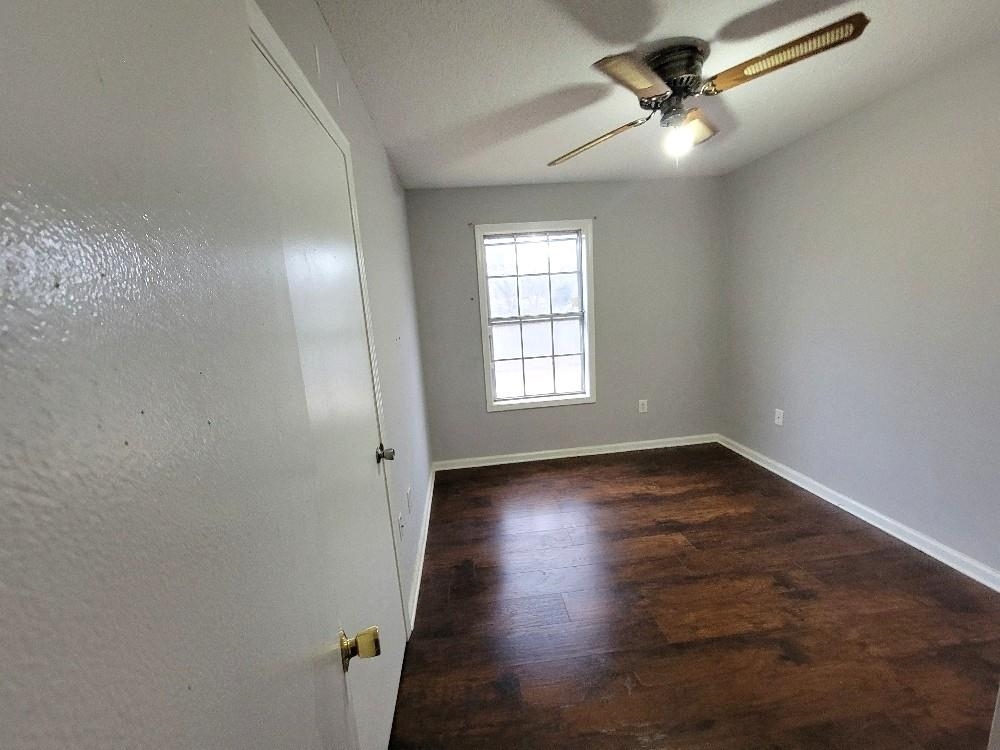 4063 Double Tree Road Memphis, TN 38109 - Photo 14 of 14 Spare room with dark hardwood / wood-style floors and ceiling fan