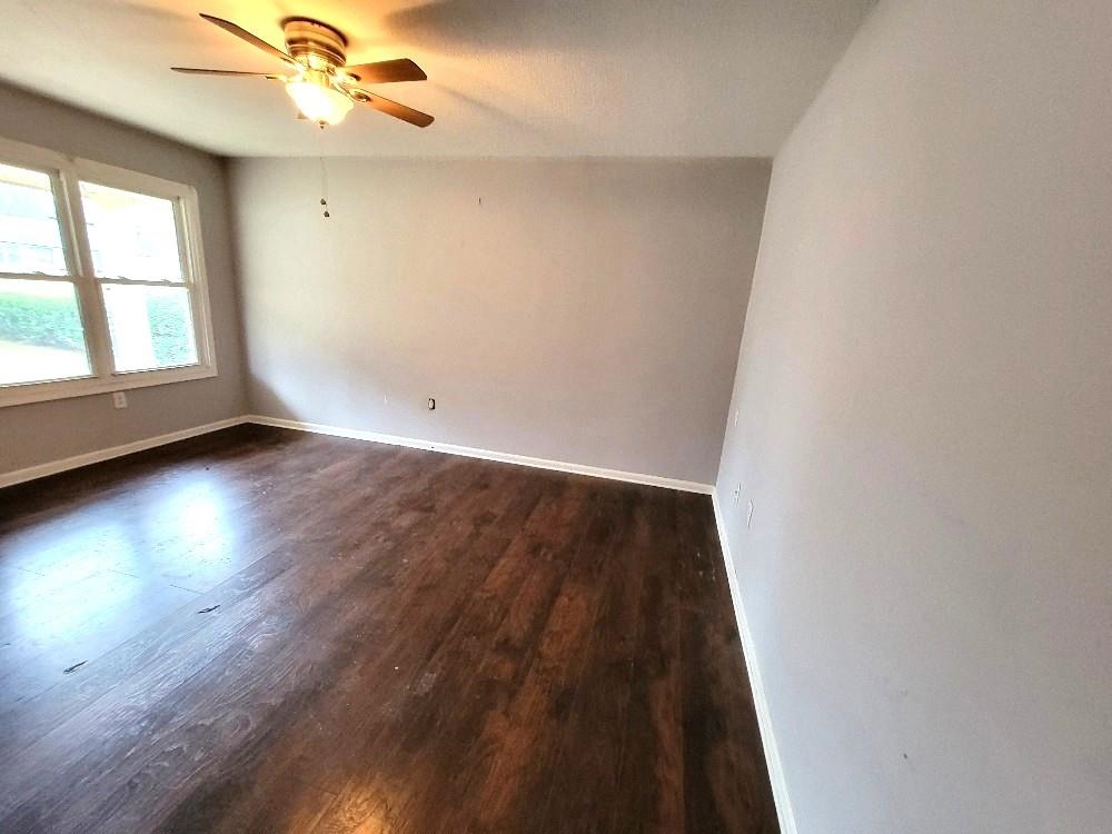 4063 Double Tree Road Memphis, TN 38109 - Photo 3 of 14 Unfurnished room with ceiling fan and dark wood-type flooring
