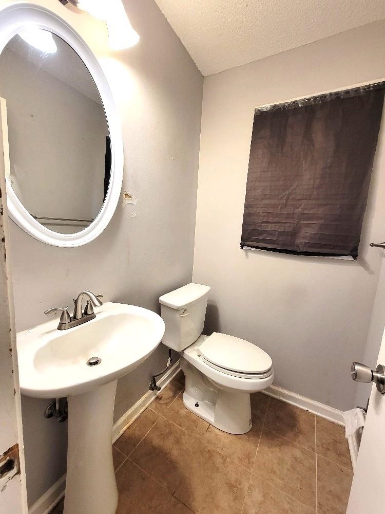 4063 Double Tree Road Memphis, TN 38109 - Photo 9 of 14 Bathroom with tile patterned flooring, toilet, and a textured ceiling