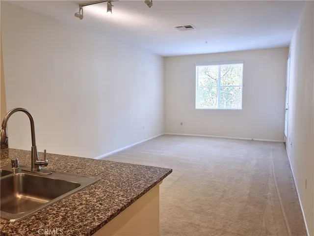 a view of a kitchen sink a faucet and appliance in the kitchen