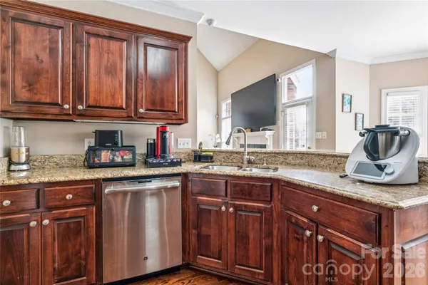 a kitchen with granite countertop stainless steel appliances and cabinets
