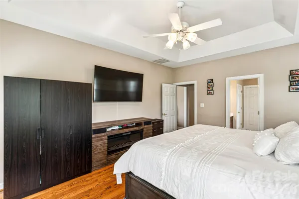 a bedroom with a bed and a chandelier