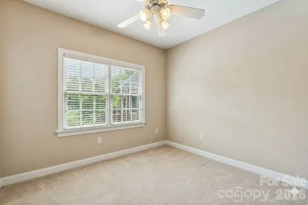 an empty room with wooden floor and closet area