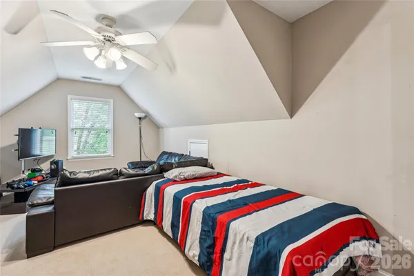 a bathroom with a granite countertop sink a toilet and a mirror